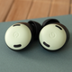 A close-up of the Pixel Buds Pro earbuds sitting on a Pixel 5 smartphone.